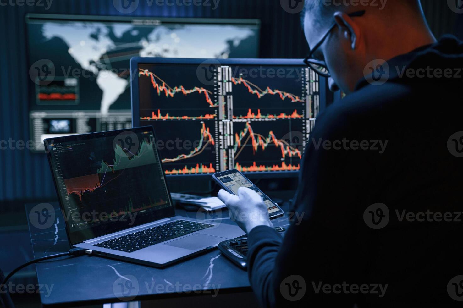 Financial, Analyst ,Working on a Computer with Multi-Monitor Workstation with Real-Time Stocks, Commodities and Exchange Market Charts. photo