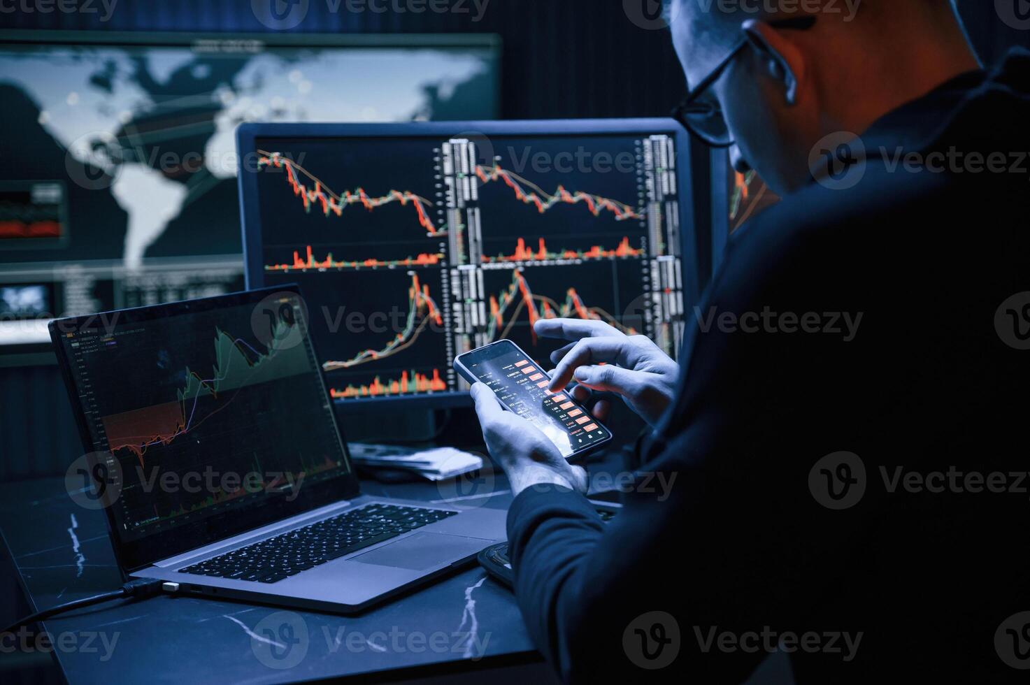 Financial, Analyst Working on a Computer with Multi-Monitor Workstation with Real-Time Stocks, Commodities and Exchange Market Charts. photo