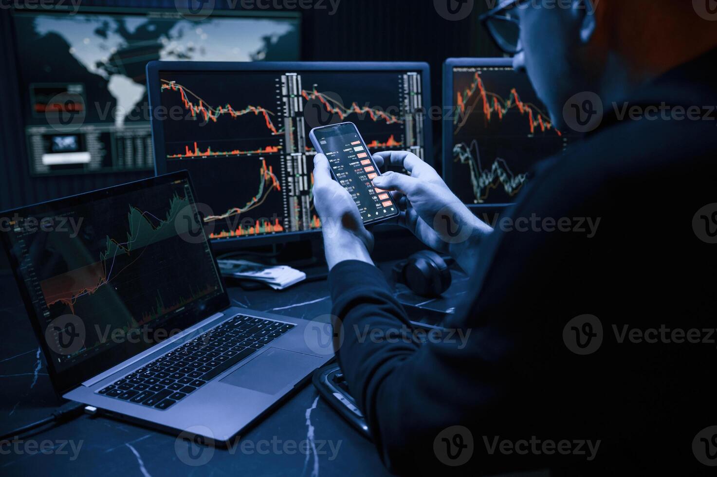 Financial Analyst,, Working on a Computer with Multi-Monitor Workstation with Real-Time Stocks, Commodities and Exchange Market Charts. photo