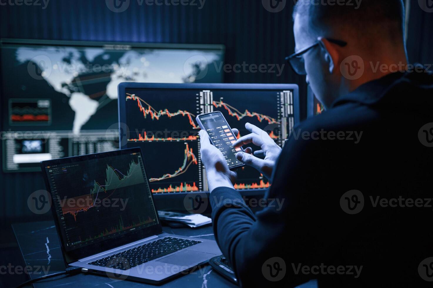 Financial Analyst Working on ,a Computer with Multi-Monitor Workstation with Real-Time Stocks, Commodities and Exchange Market Charts. photo