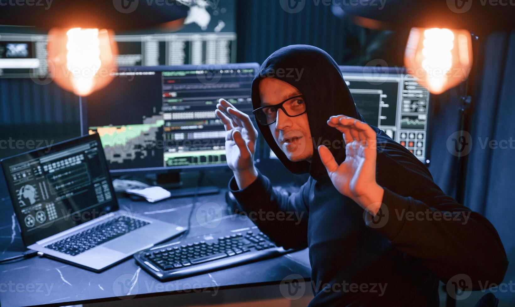 Got, caught. With hands up. Male professional hacker is sitting by computer, conception of virus photo