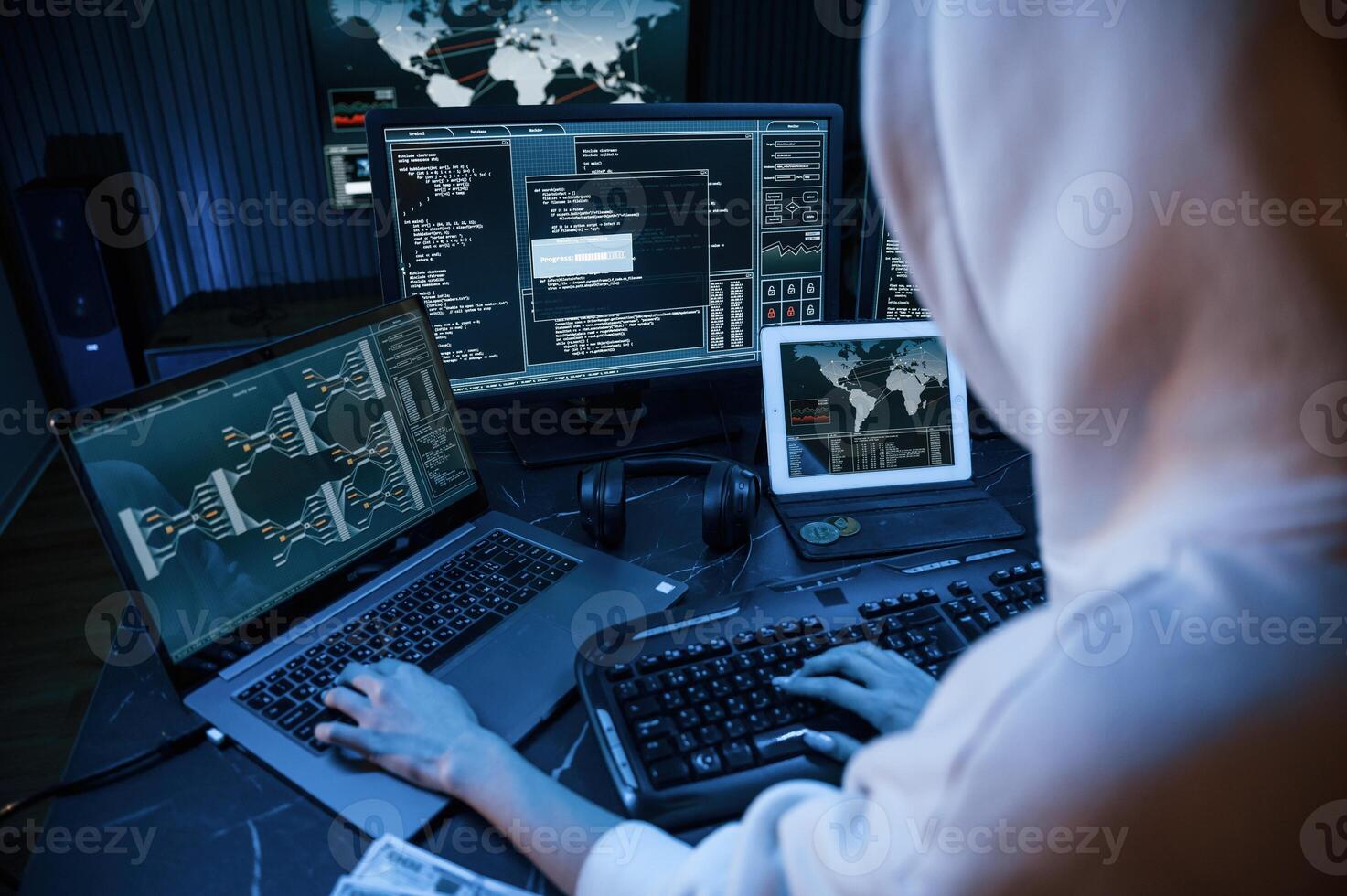 Phishing attack. Young professiona,l female ,hacker is indoors by computer with lot of information on displays photo