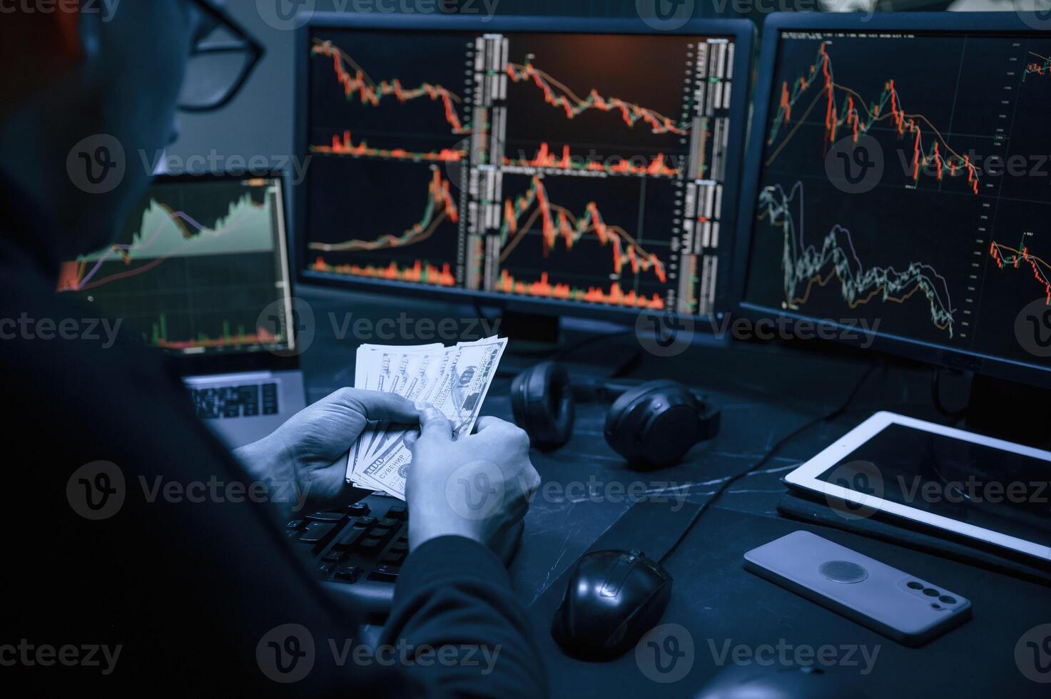Financial Analyst, Working ,on a Computer, with Multi-Monitor Workstation with Real-Time Stocks, Commodities and Exchange Market Charts. photo