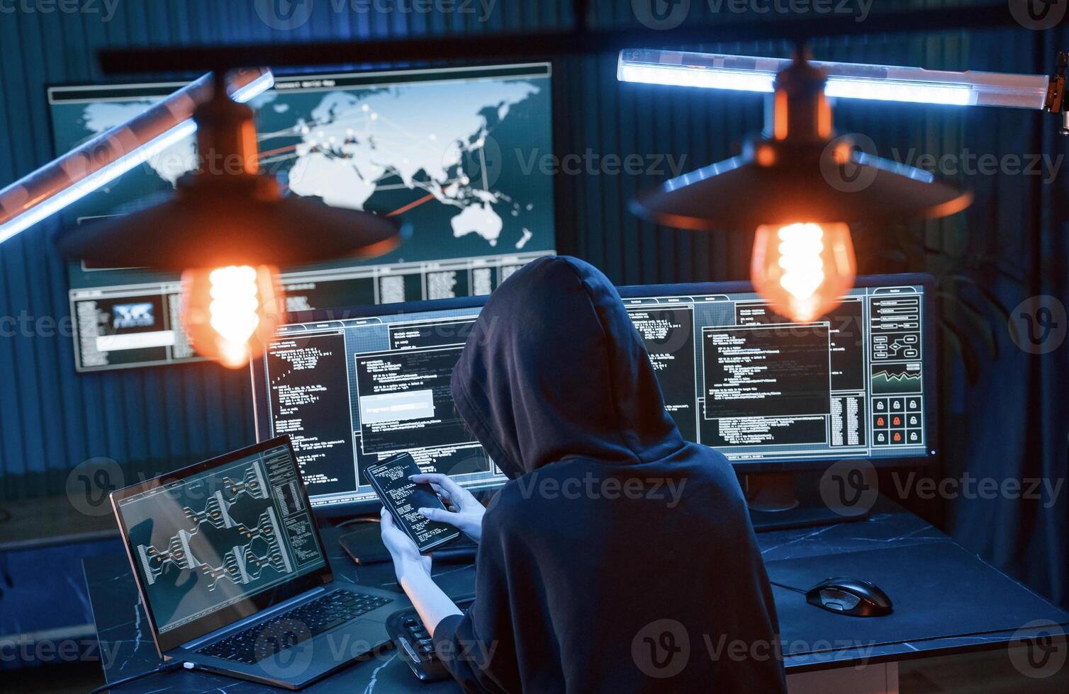 Modern technology. .Young professional female hacker is indoors by computer with lot of information on displays photo