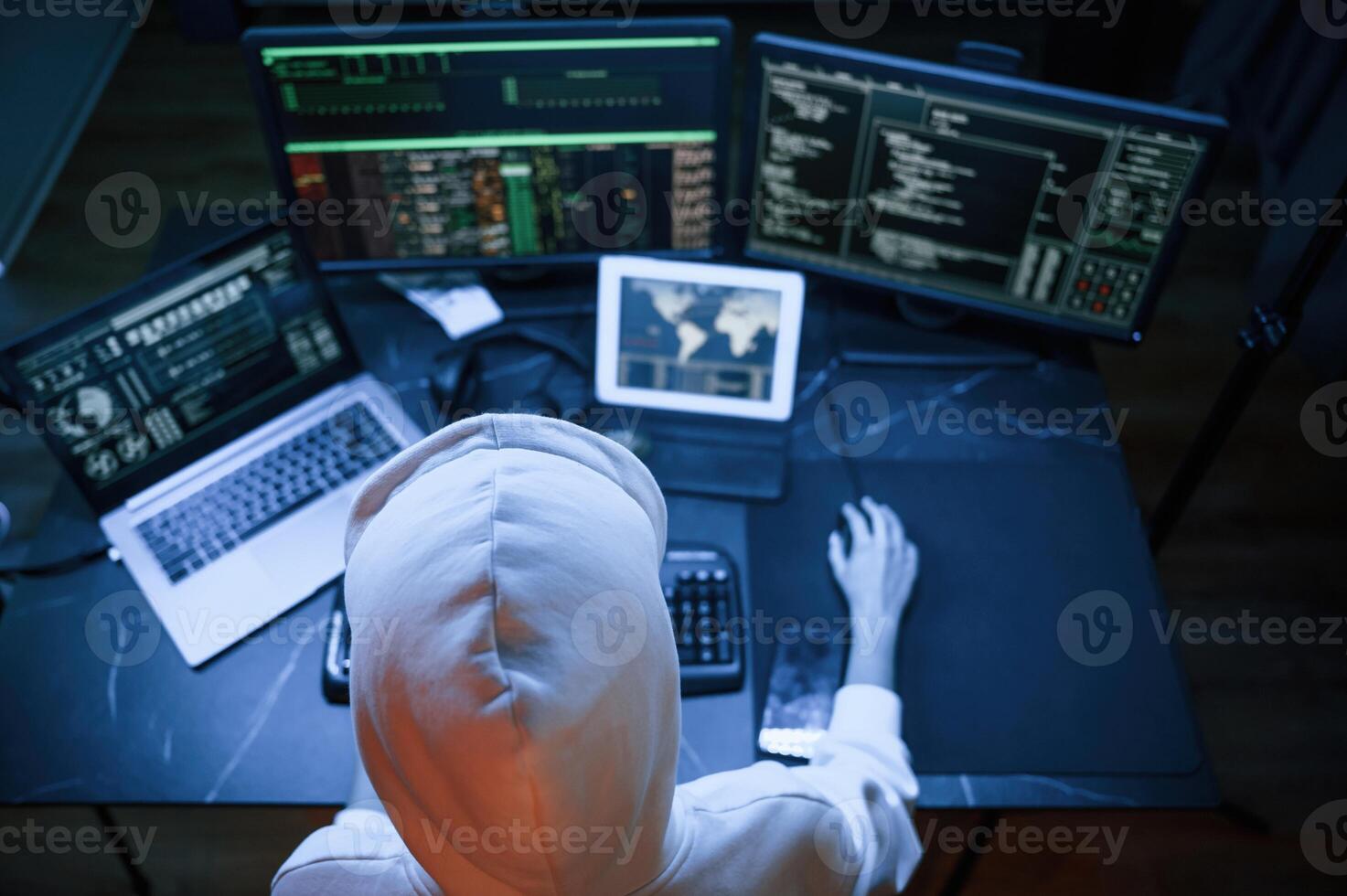 Top view. .Young professional female hacker ,is .ndoors by computer with lot of information on displays photo