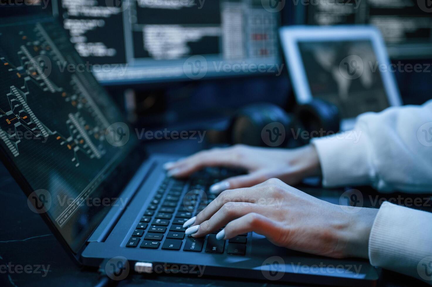 Side close up view of female hacker hands, typing on keyboard.. photo