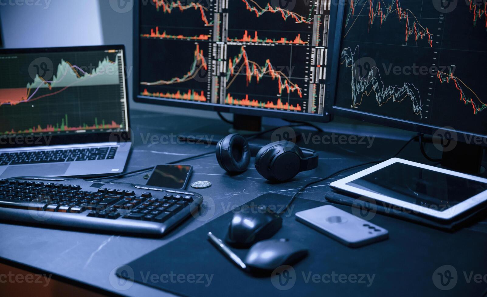 Financial Analyst Working on a ,Computer ,with Multi-Monitor Workstation with Real-Time Stocks, Commodities and Exchange Market Charts. photo