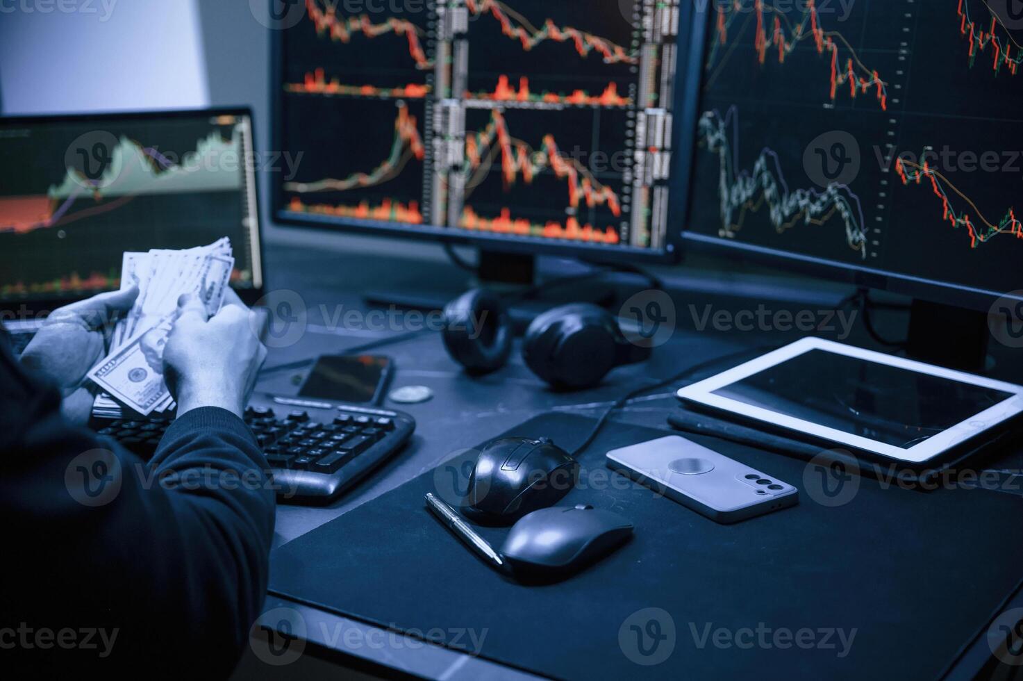 Financial Analyst Working on a, Computer ,with, Multi-Monitor Workstation with Real-Time Stocks, Commodities and Exchange Market Charts. photo