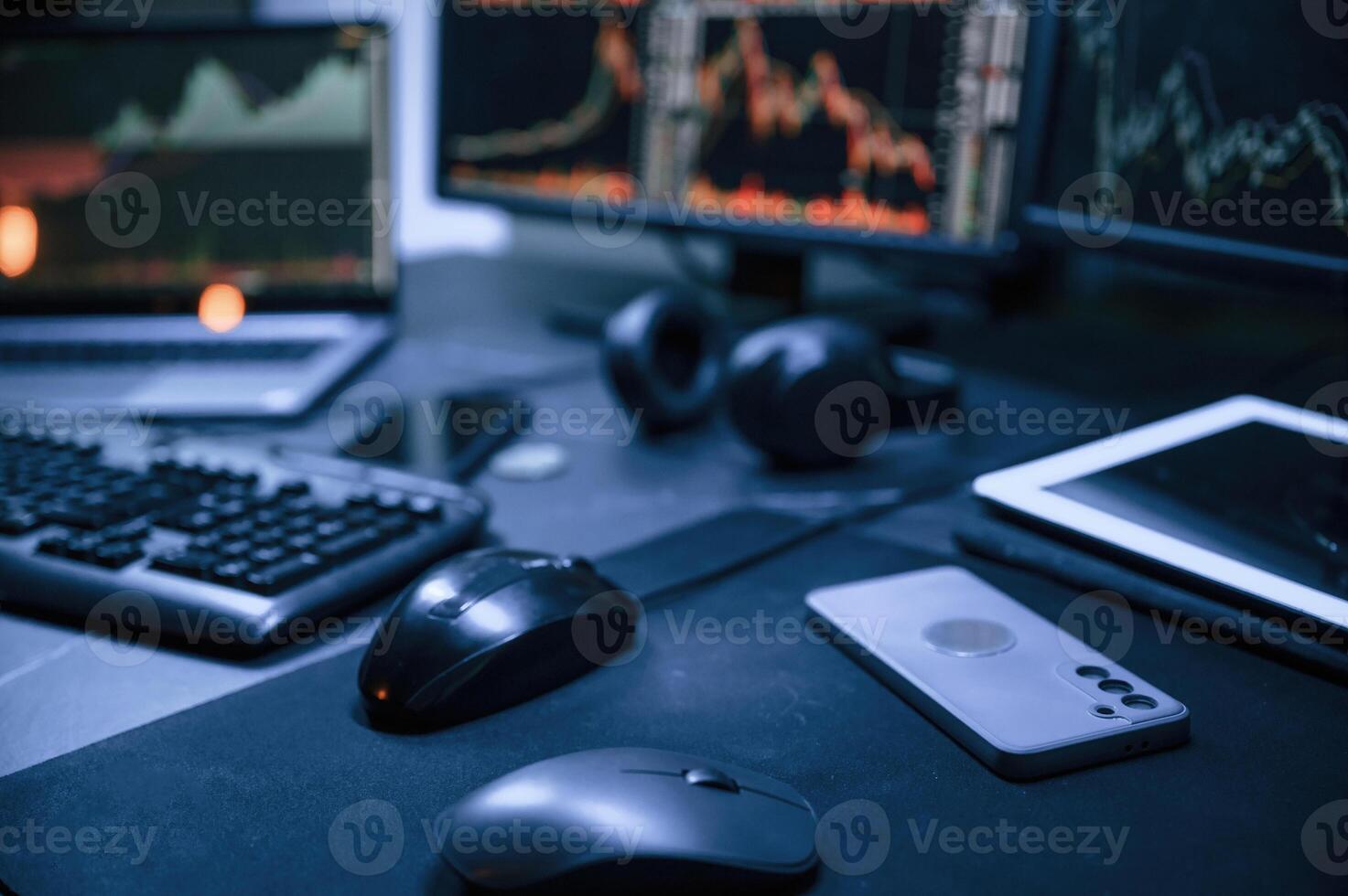 Financial Analyst Working on, a Computer with MultiMonitor Workstation with Real-Time Stocks, Commodities and Exchange Market Charts. photo