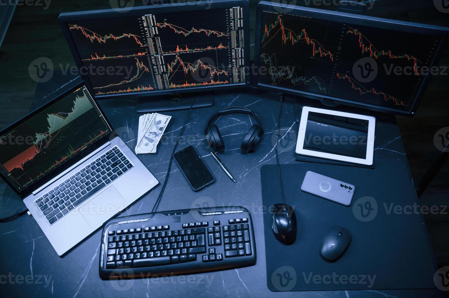 Financial Analyst Working on a Computer with ,Multi-Monitor Workstation with Real-Time Stocks, Commodities and Exchange Market Charts. photo