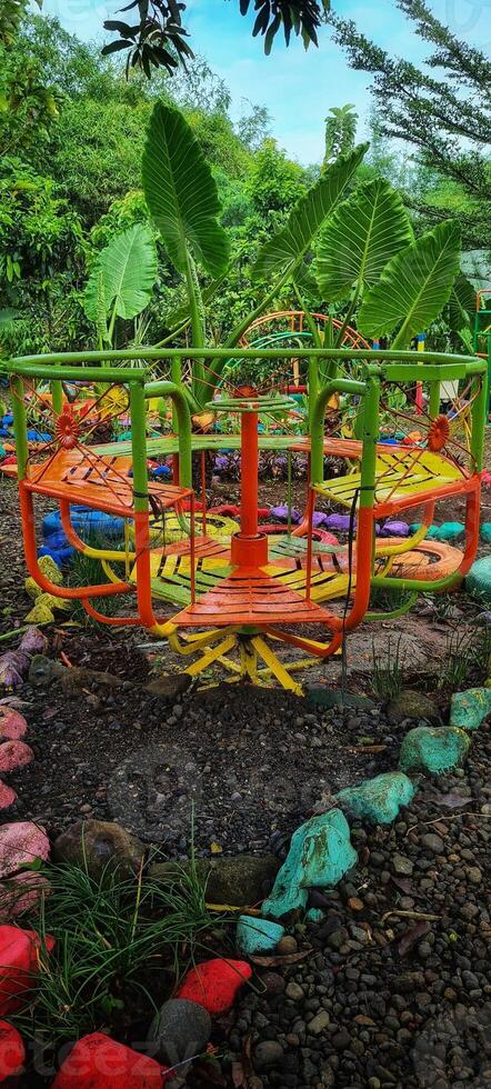 A colorful swing in a tropical garden photo