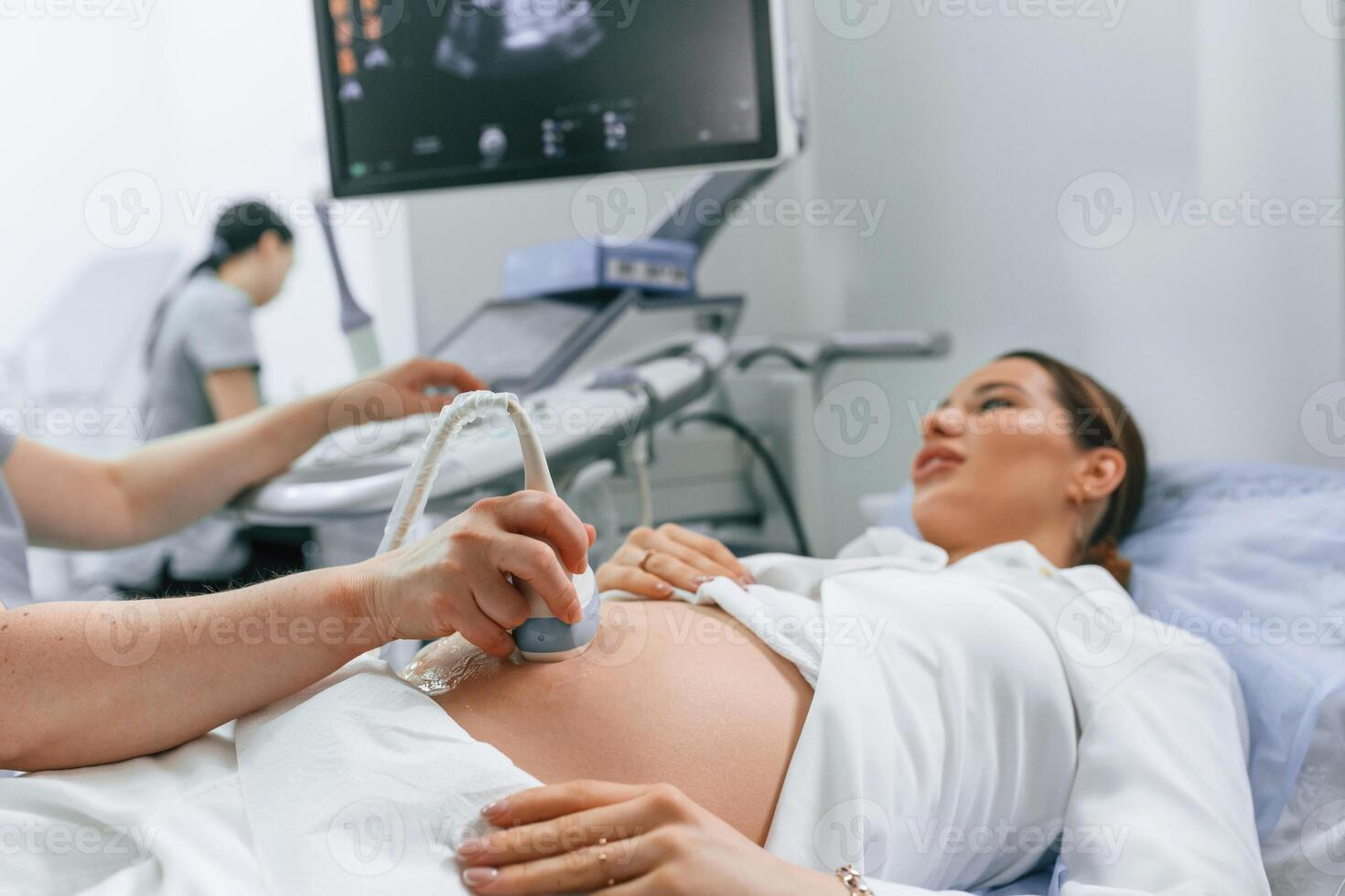 Close, up, view, scanning. Pregnant woman is lying down in the hospital, doctor does ultrasound photo