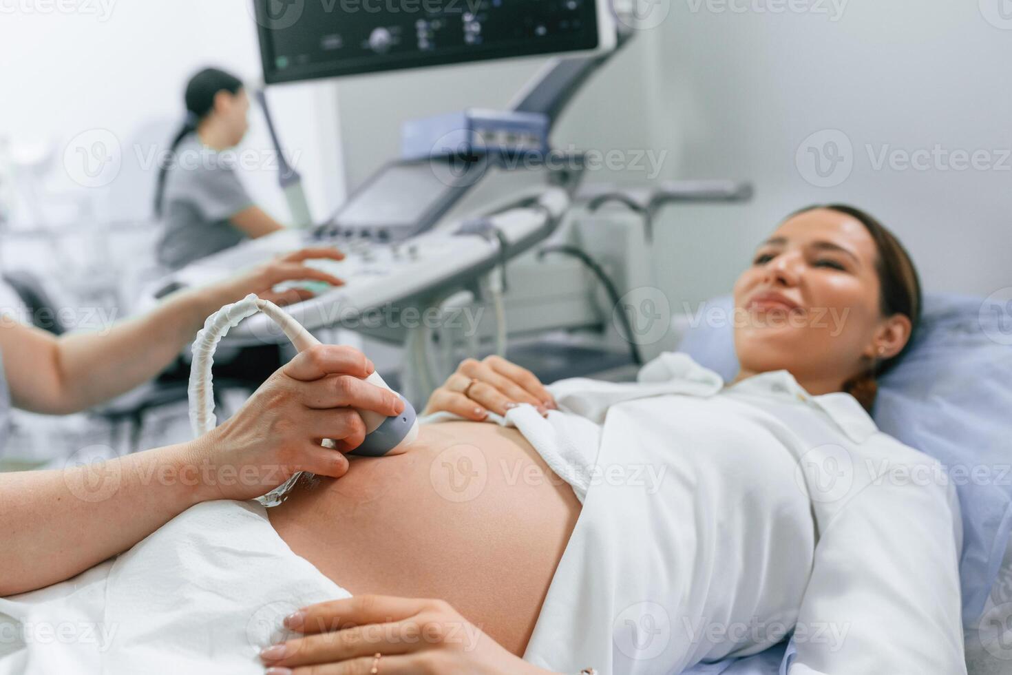 Close up view, scanning... Pregnant woman is lying down in the hospital, doctor does ultrasound photo