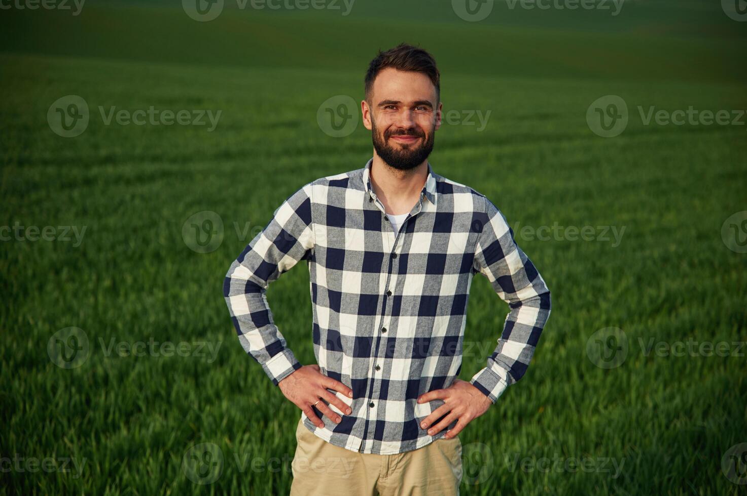 On agricultural field... Handsome, young man photo