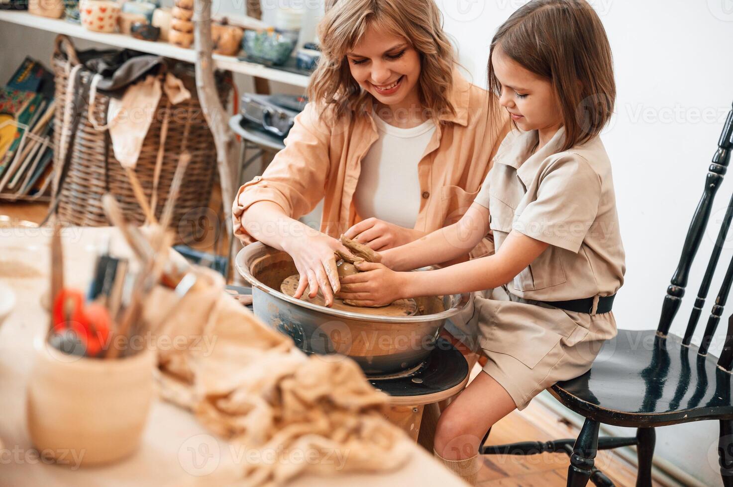 Clay, modeling,. Mother with, little girl doing pottery at home photo