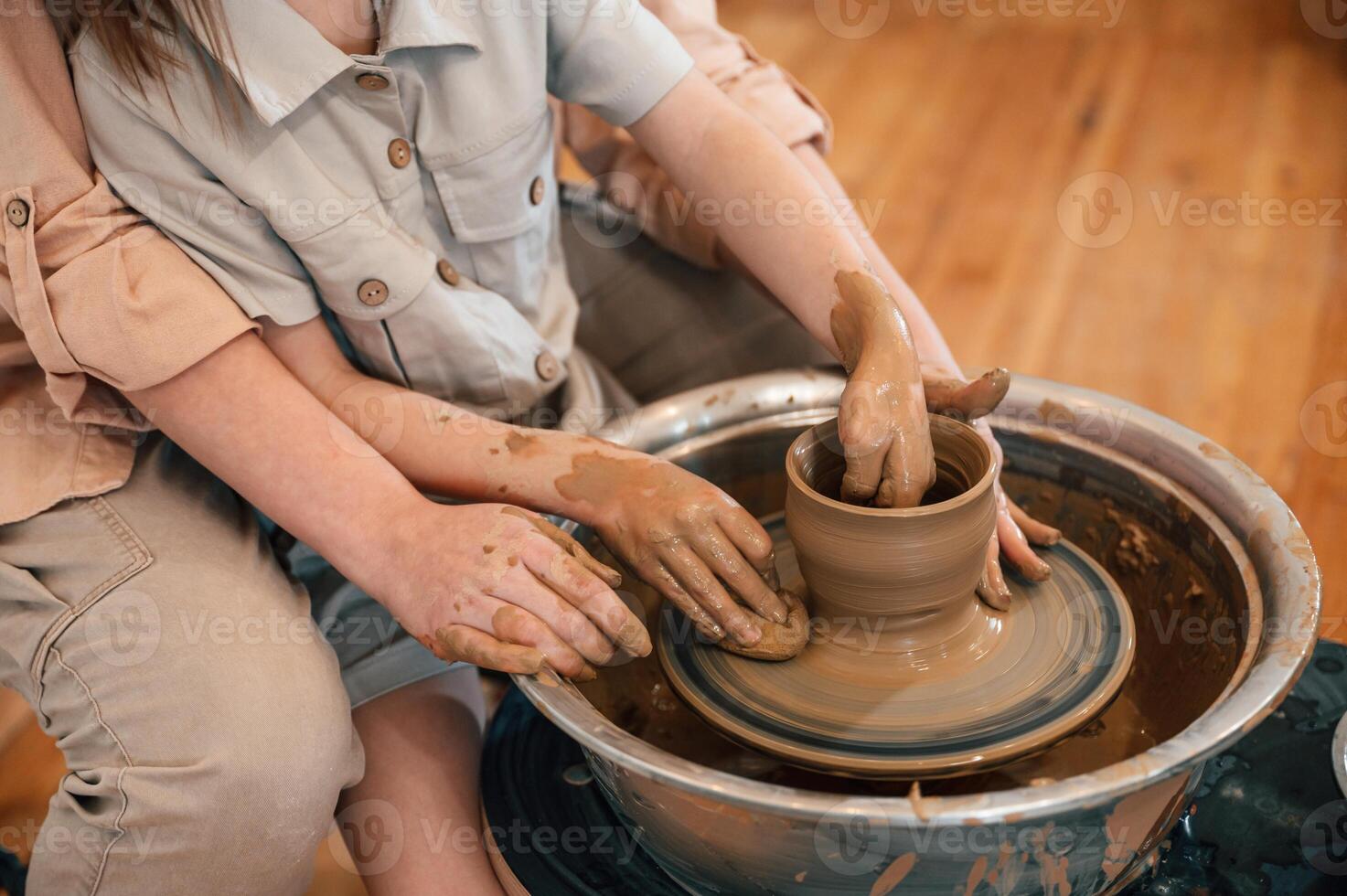 Close up ,view. Mother with little girl doing pottery at home photo