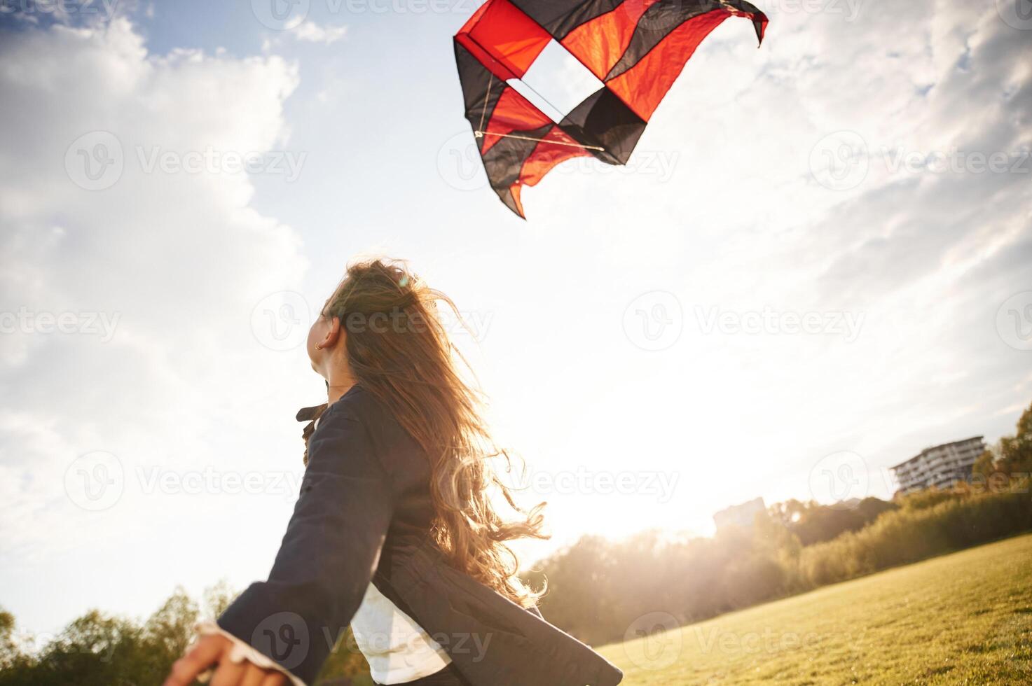 Beautiful, sunlight.. Happy, little girl is playing with kite on the summer field photo