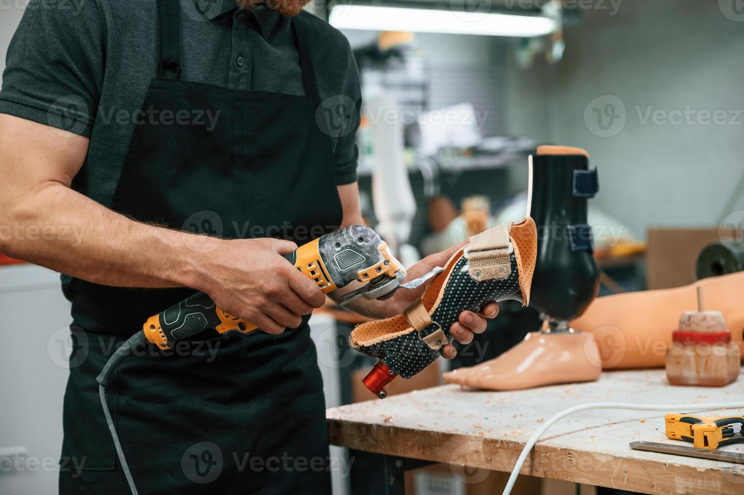 Cuts, the ,material with drill. Technician working with prosthesis in modern laboratory photo
