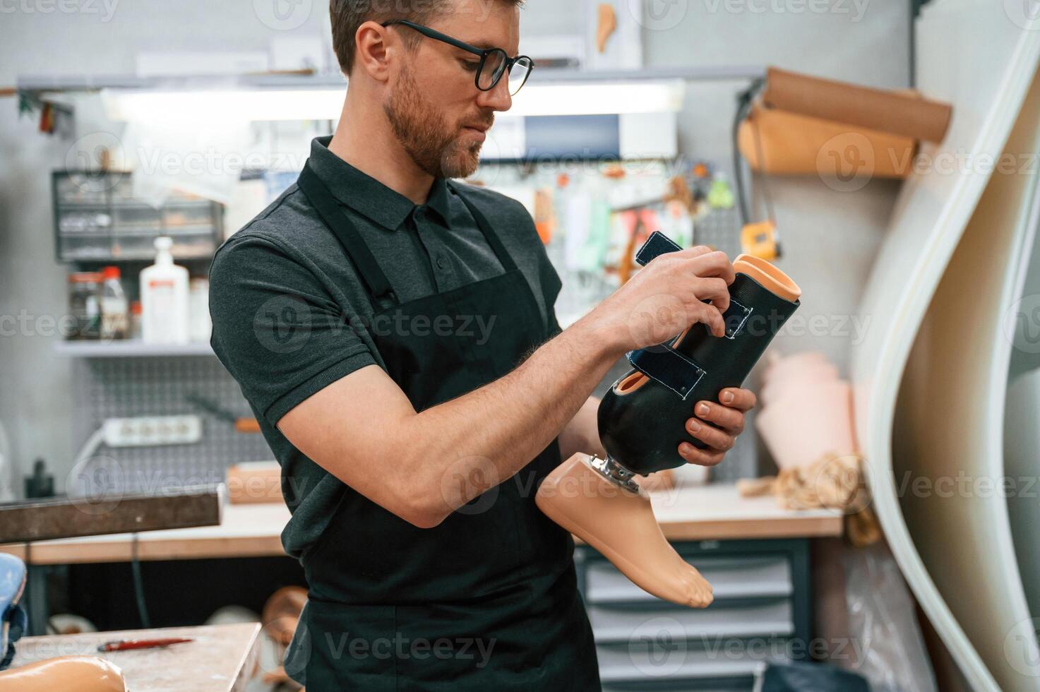 Holding prosthesis., Technician working in modern laboratory photo