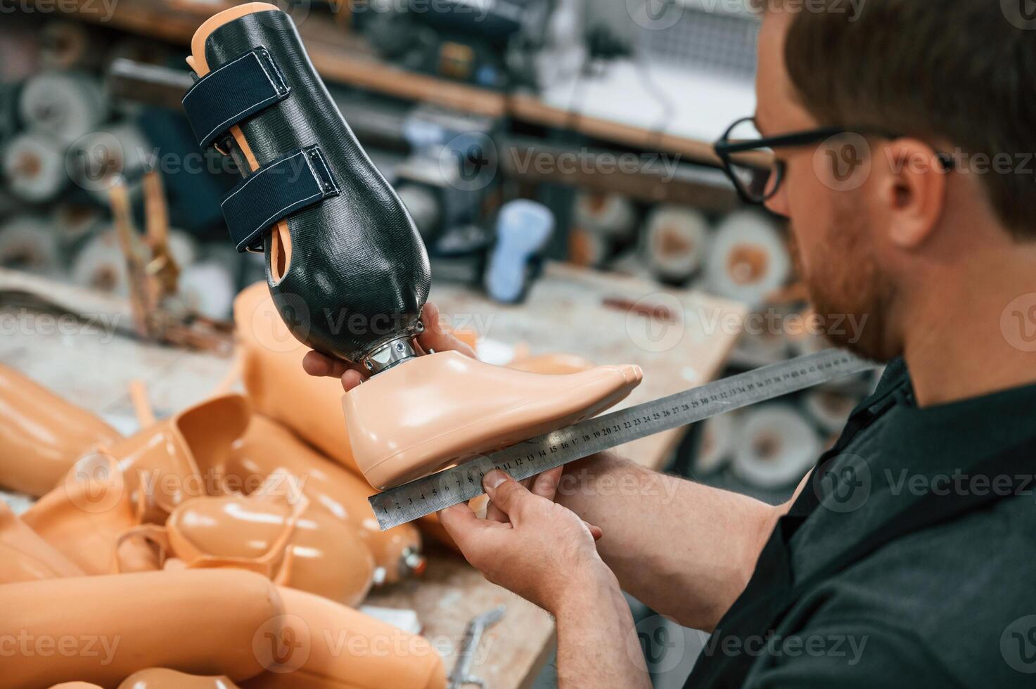 Measuring the prosthesis. Technician working in modern ,,laboratory photo