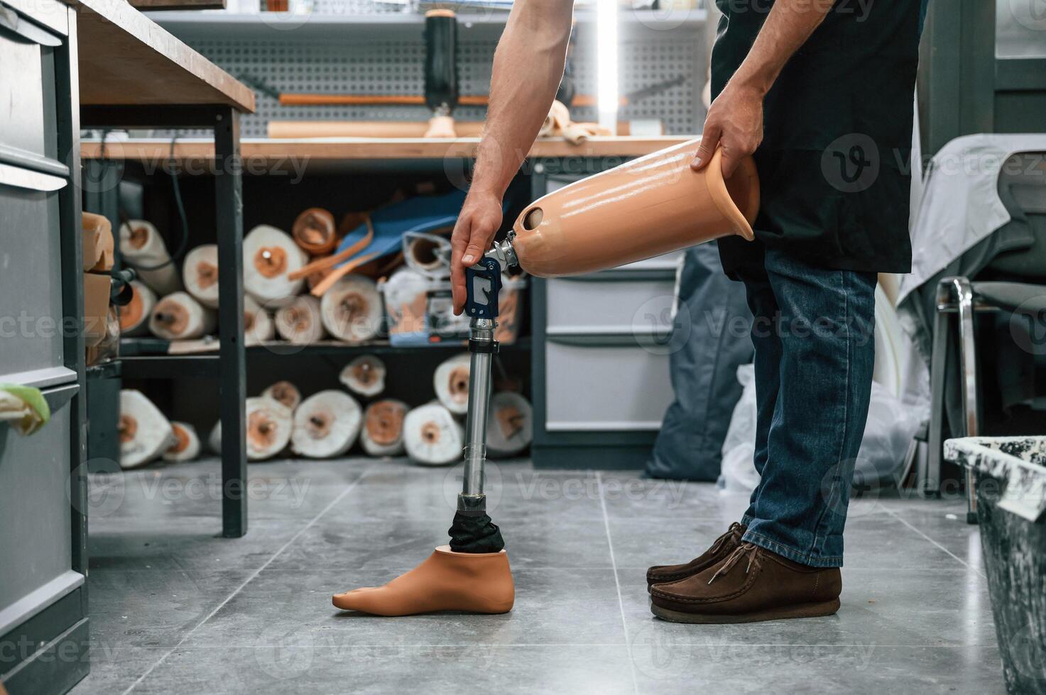 Prosthesis ,on the floor. Technician working in modern laboratory photo