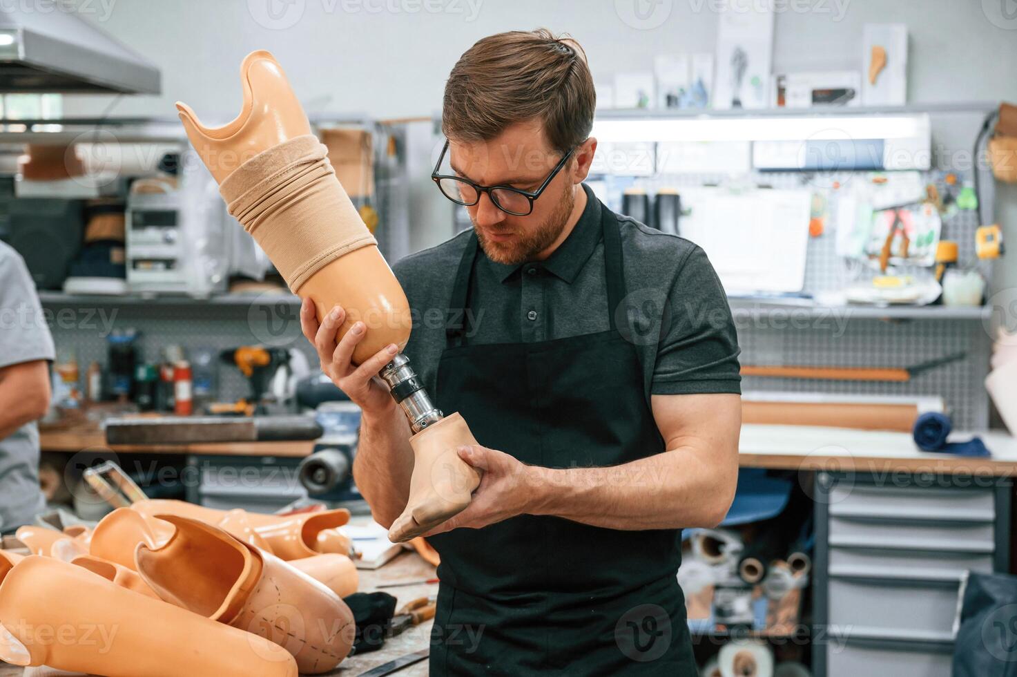 Technician working with prosthesis, in modern laboratory photo