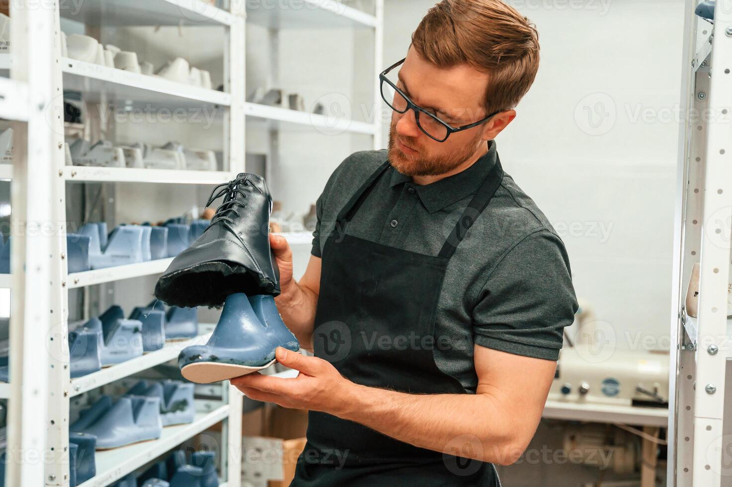 Man, is holding ,shoe in the hands. Conception of industry photo