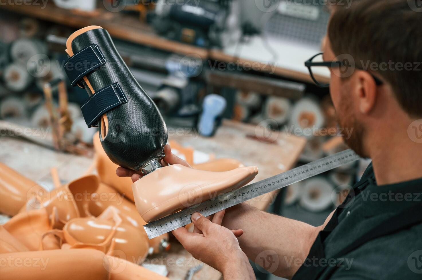 Measuring ,the prosthesis. Technician working in modern laboratory photo