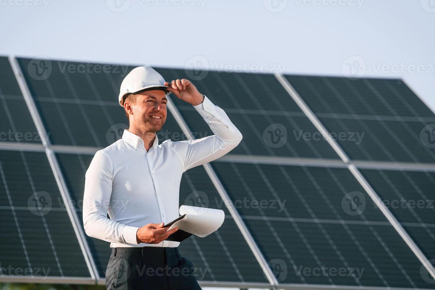 Notepad with document ,is ,in hands. Man is doing operating and maintenance in solar power plant photo