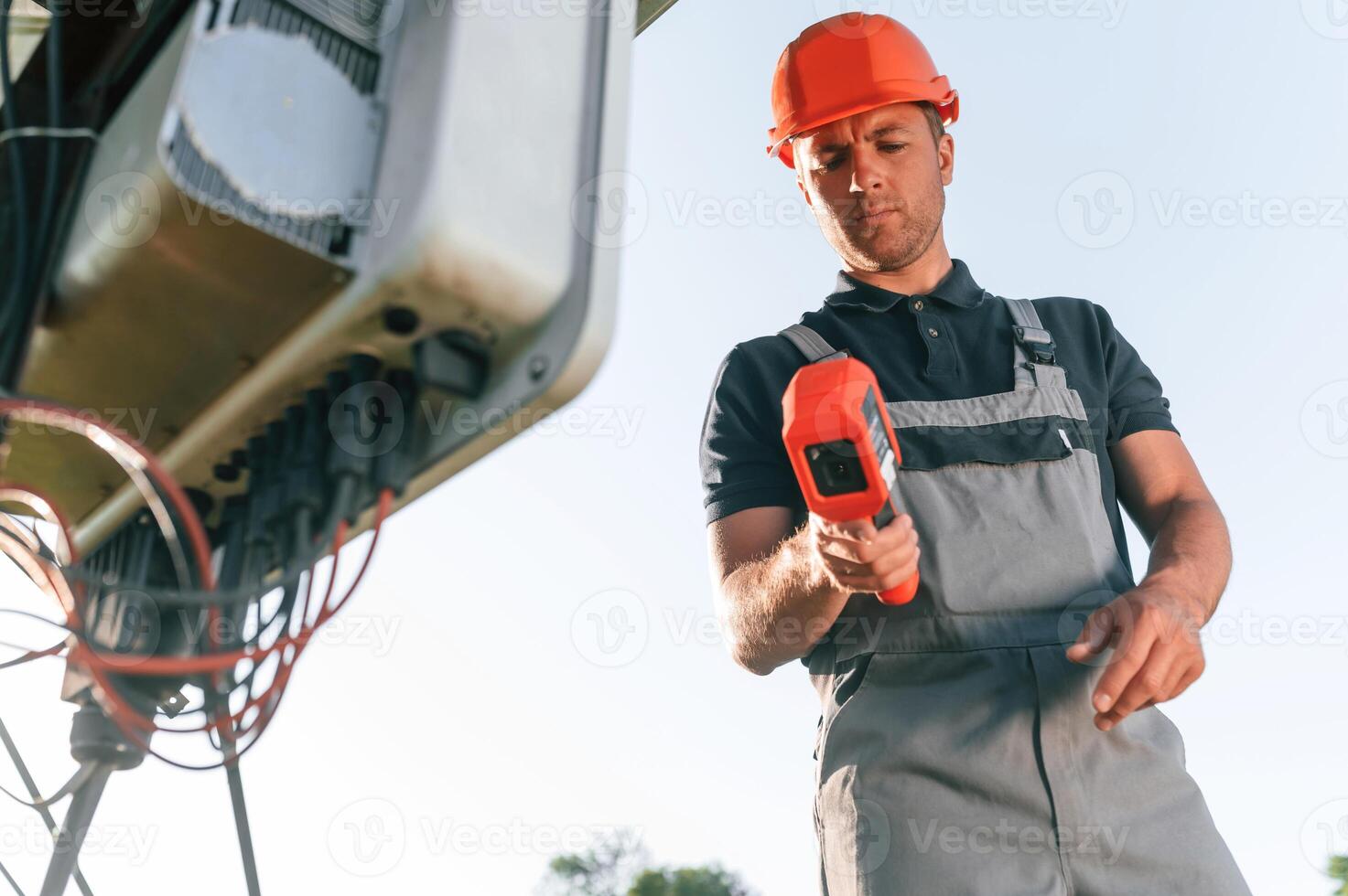 Checking ,the ,temperature ,by thermal imager. Man is doing operating and maintenance in solar power plant photo