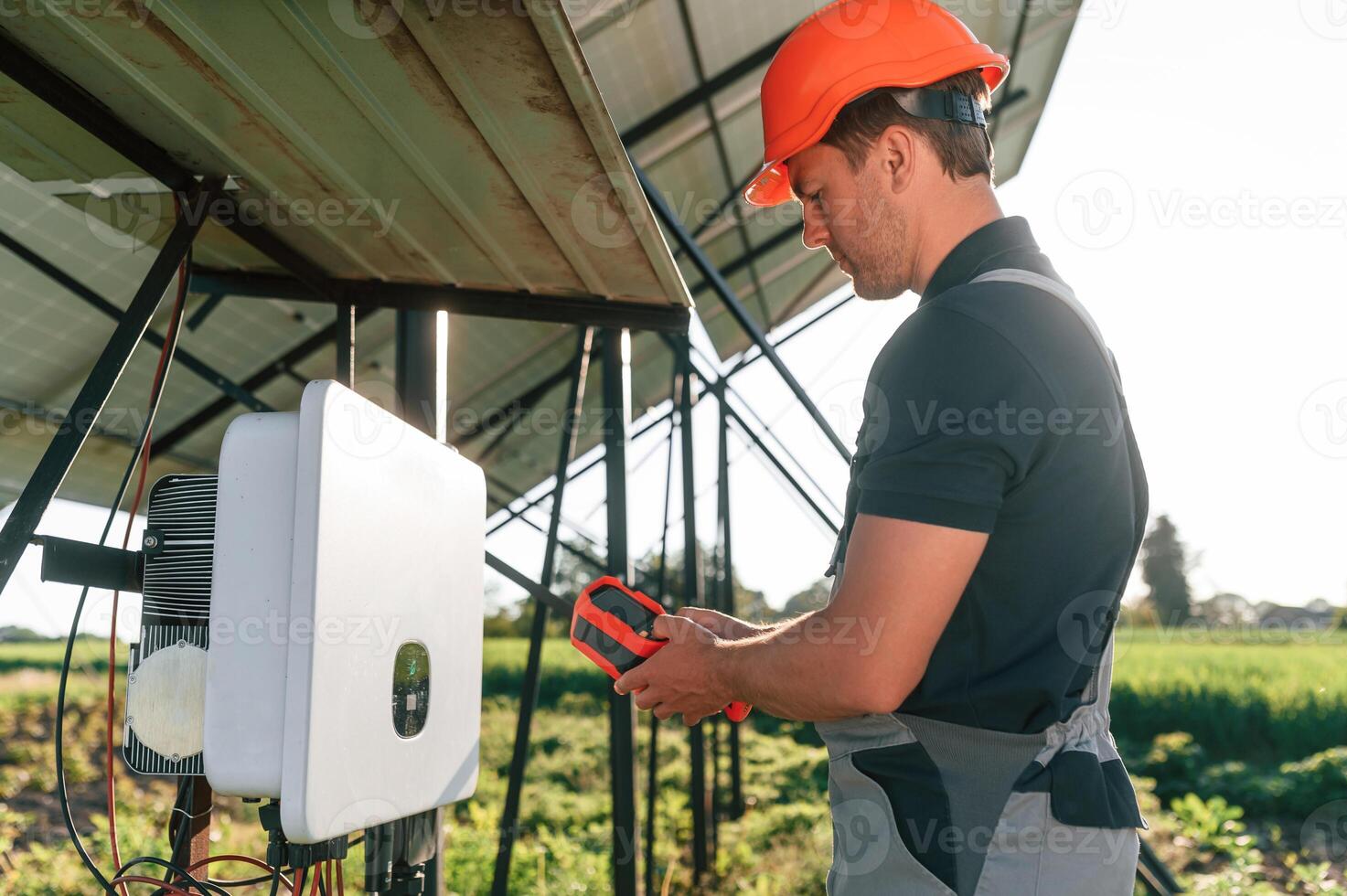Checking the temperature ,by thermal imager. Man is doing operating and maintenance in solar power plant photo