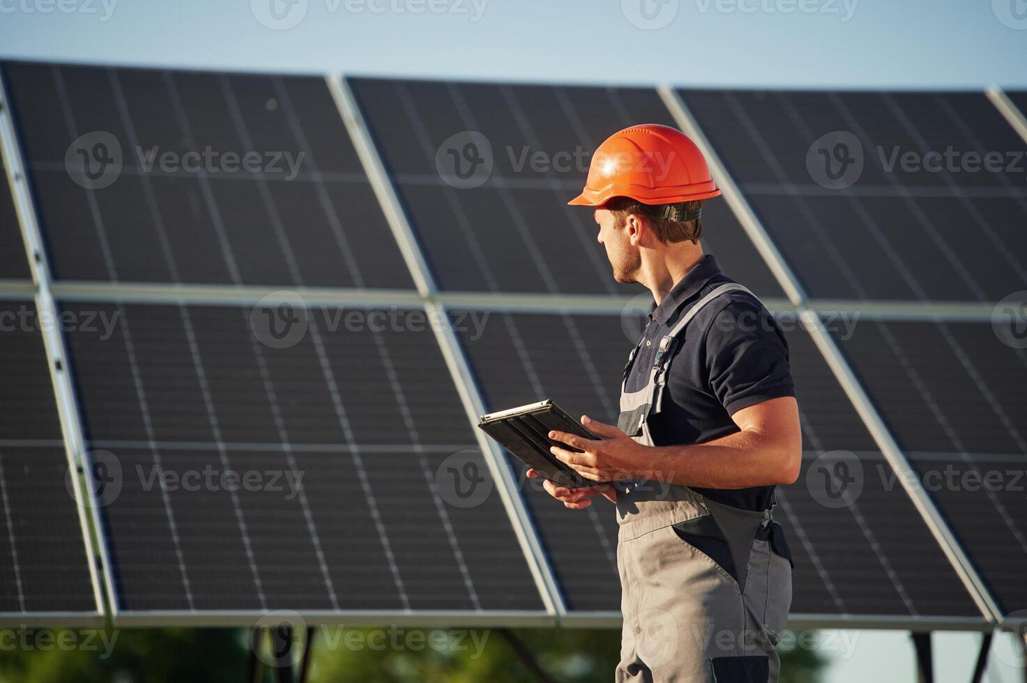 Table,t in hands. Man is doing operating and maintenance in solar power plant photo