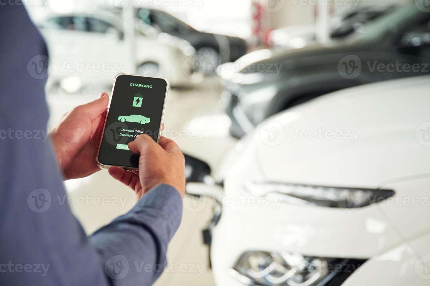 Information, of charging, process. Close up view of man that is with electrical car photo