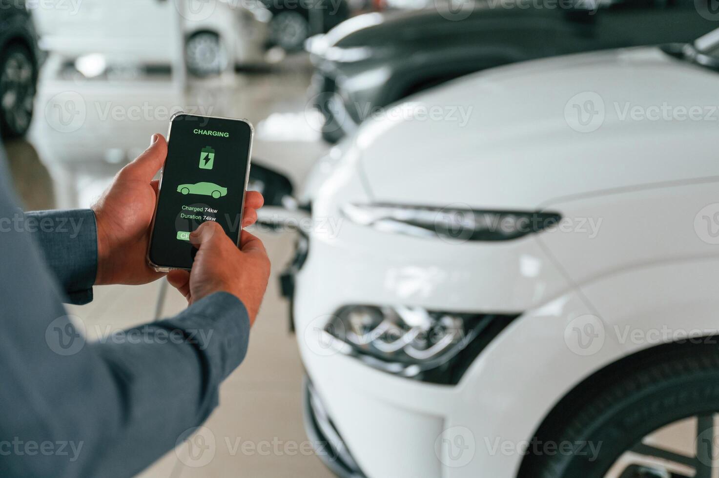 Information of charging, process. Close ,up view of man that is with electrical car photo
