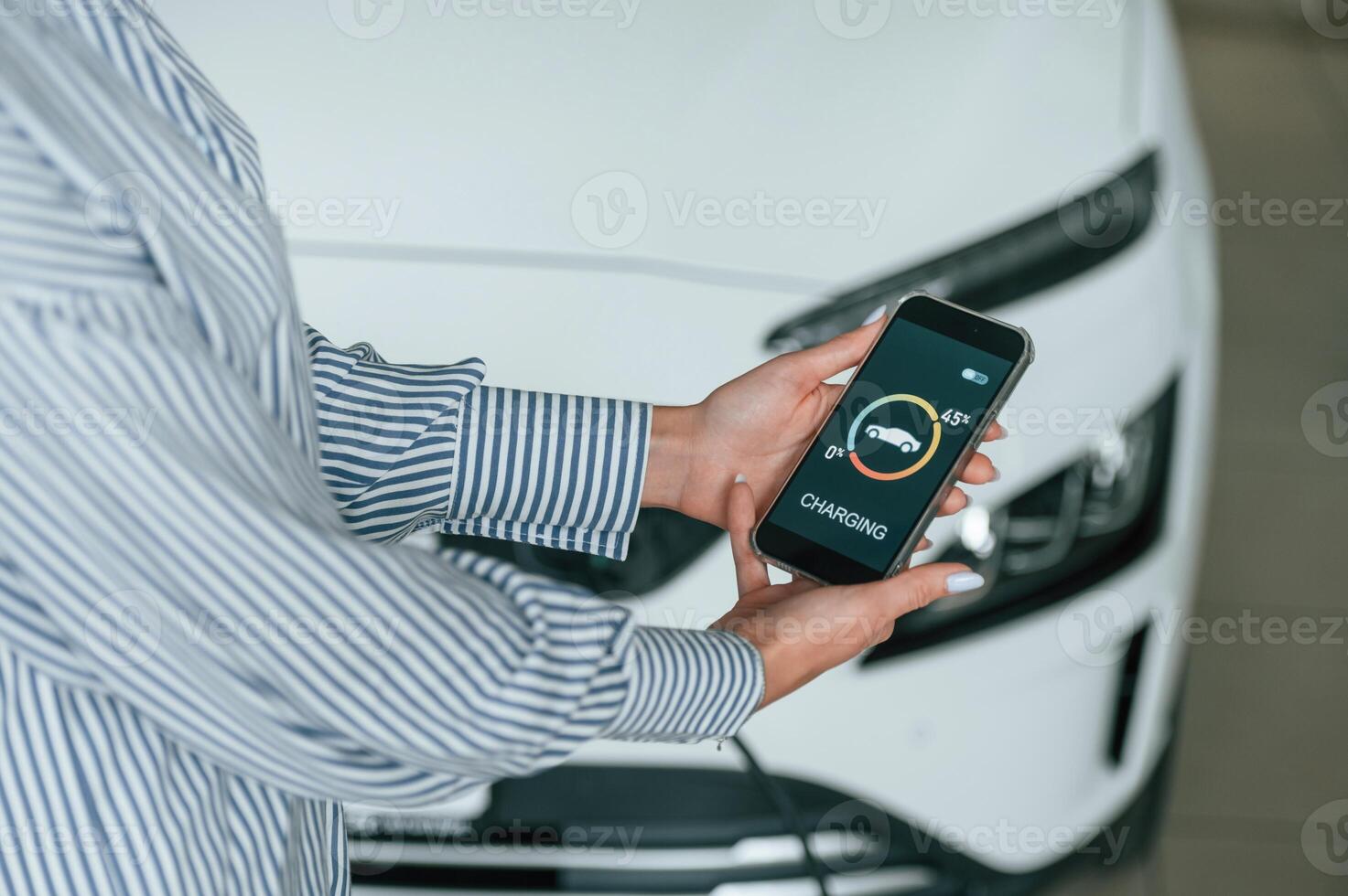 Close, up view of woman that is with ,electric car photo