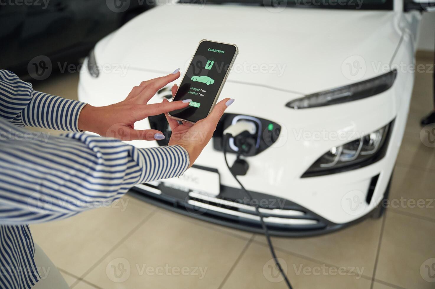 Conception of, green energy. Smartphone ,with charging process data. Close up view of woman photo