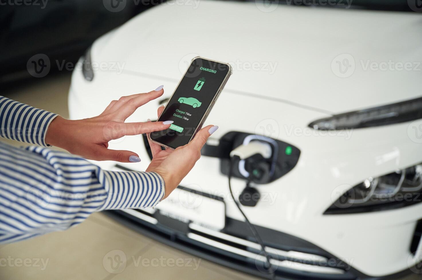 Conception of green, energy.. Smartphone with charging process data. Close up view of woman photo