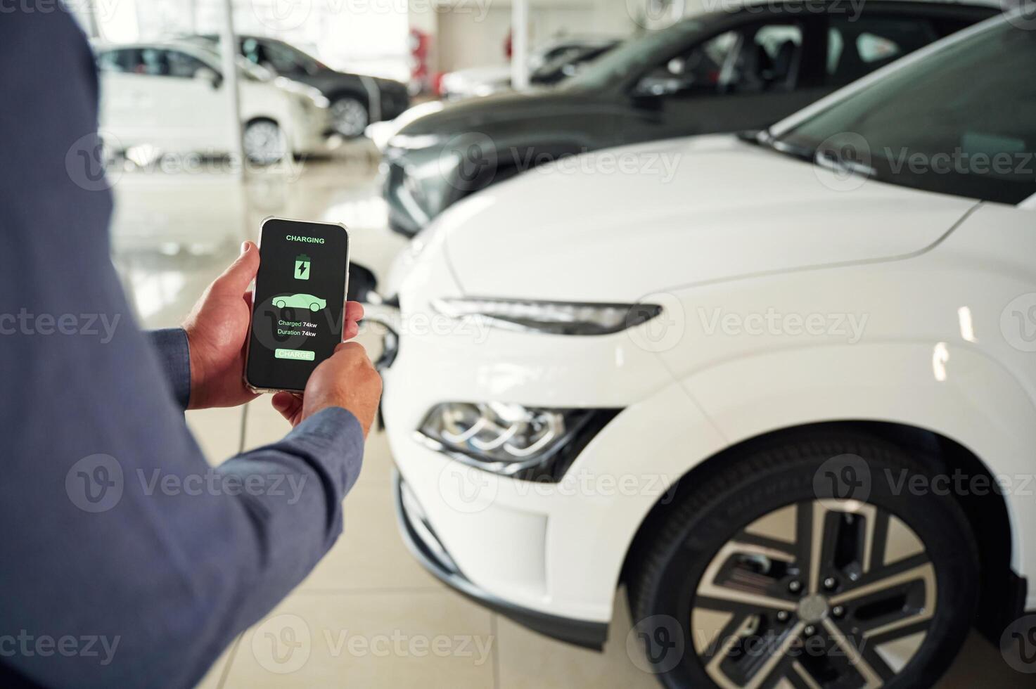 Information, of charging process. Close up view of man that is with electrical car photo