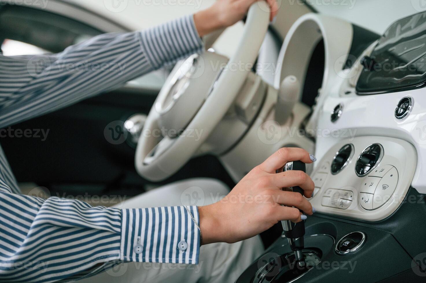 Driving the automobile.. Close up view of woman that is with electric car photo