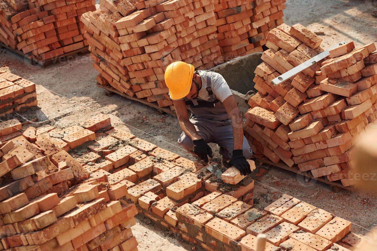 Top, view. Handsome Indian man is on the construction site photo