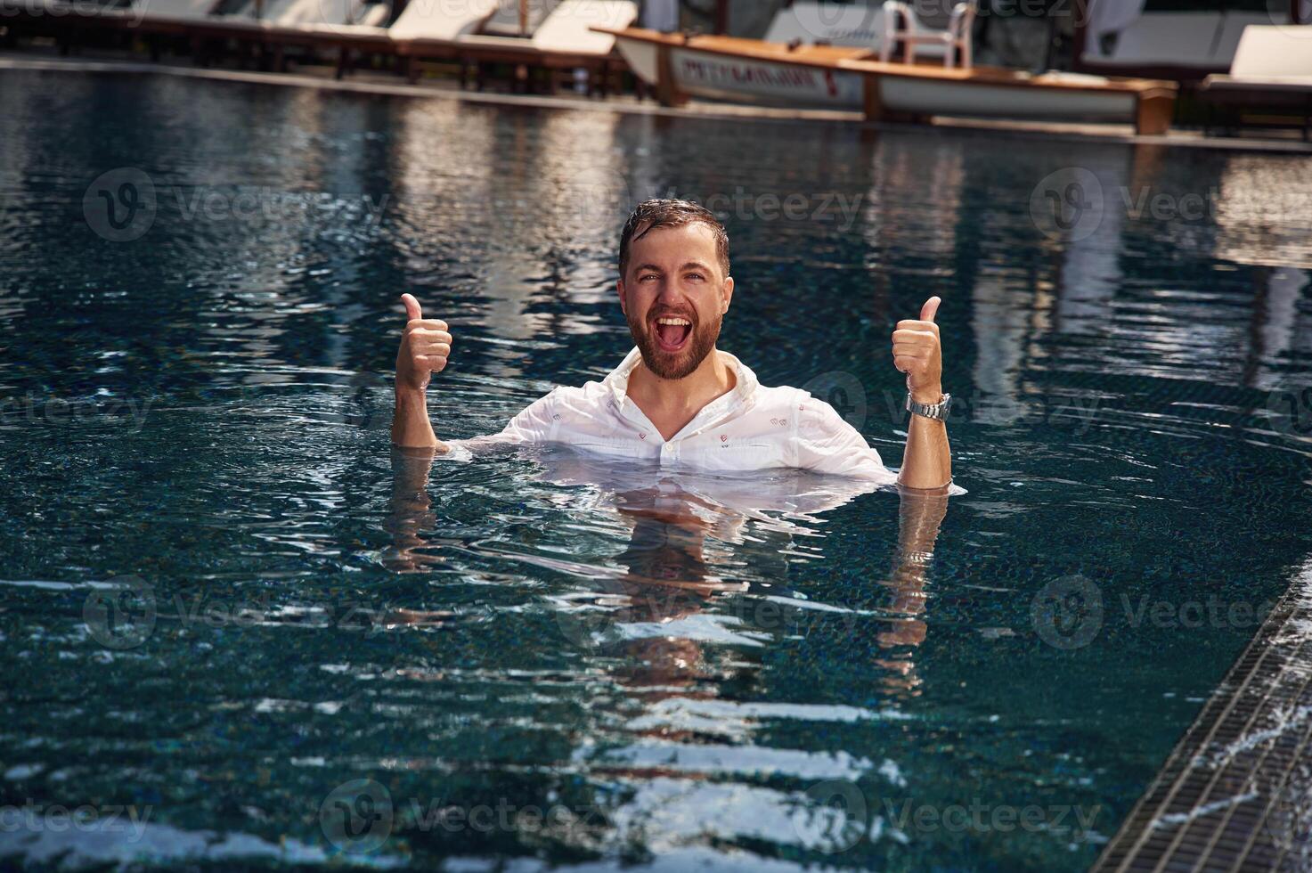Handsome man in ,formal clothes is in the pool photo