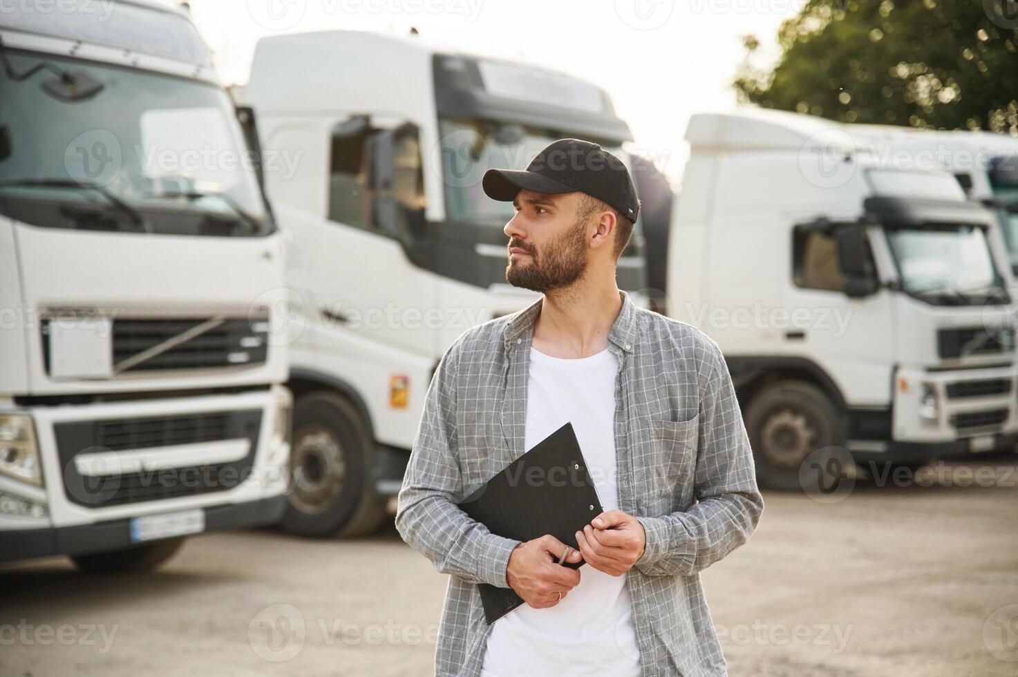 Manager, is, with notepad. Young truck driver in casual clothes photo