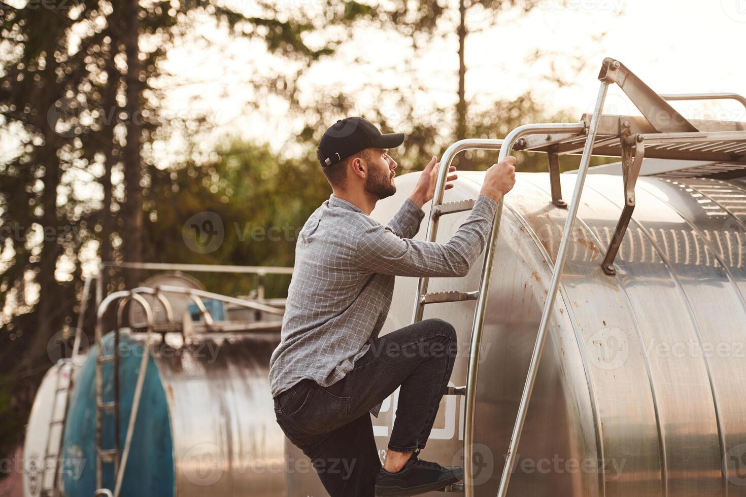 Big fuel ,tanker. Young truck driver in casual clothes photo