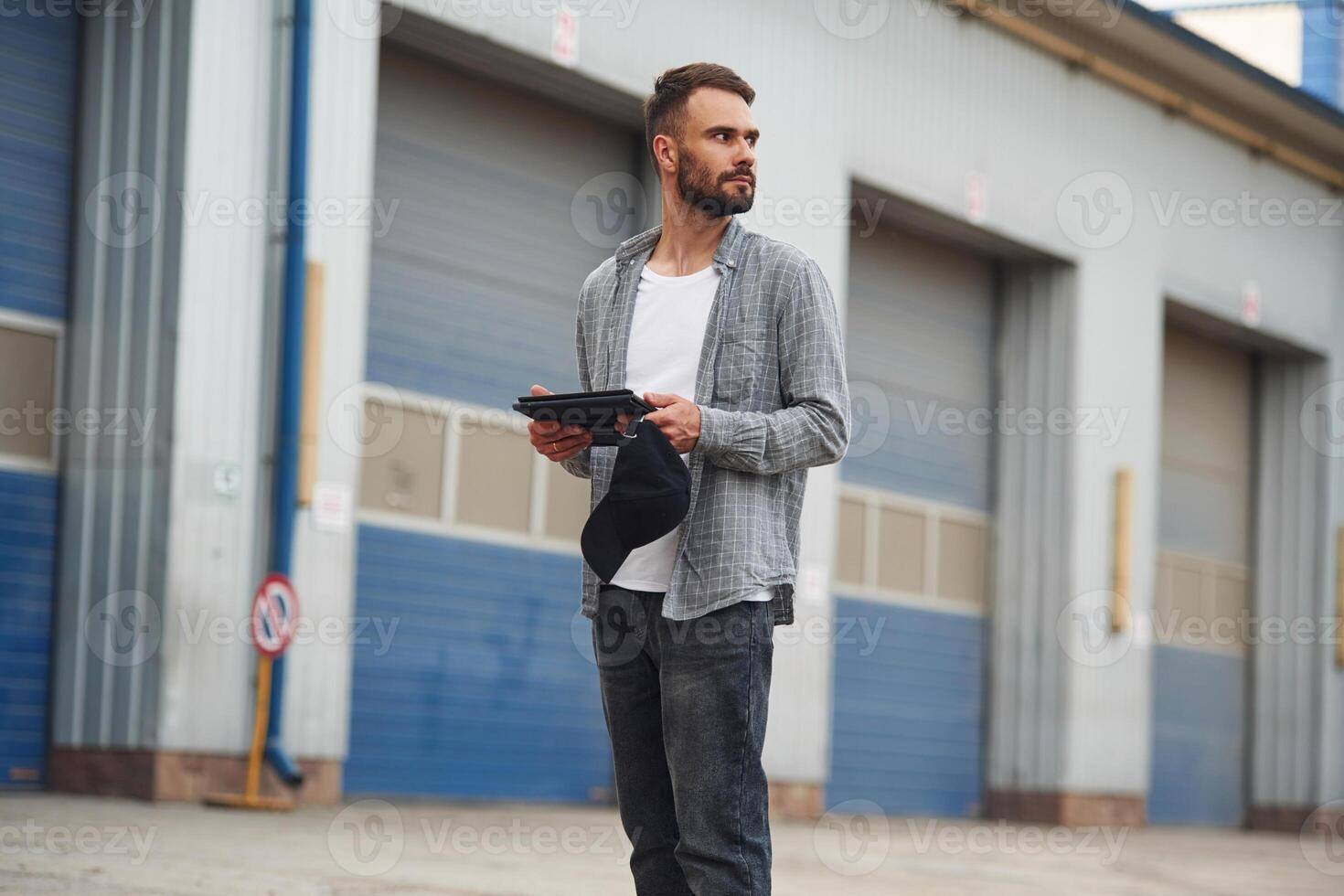 Handsome and young truck driver in casual clothes photo