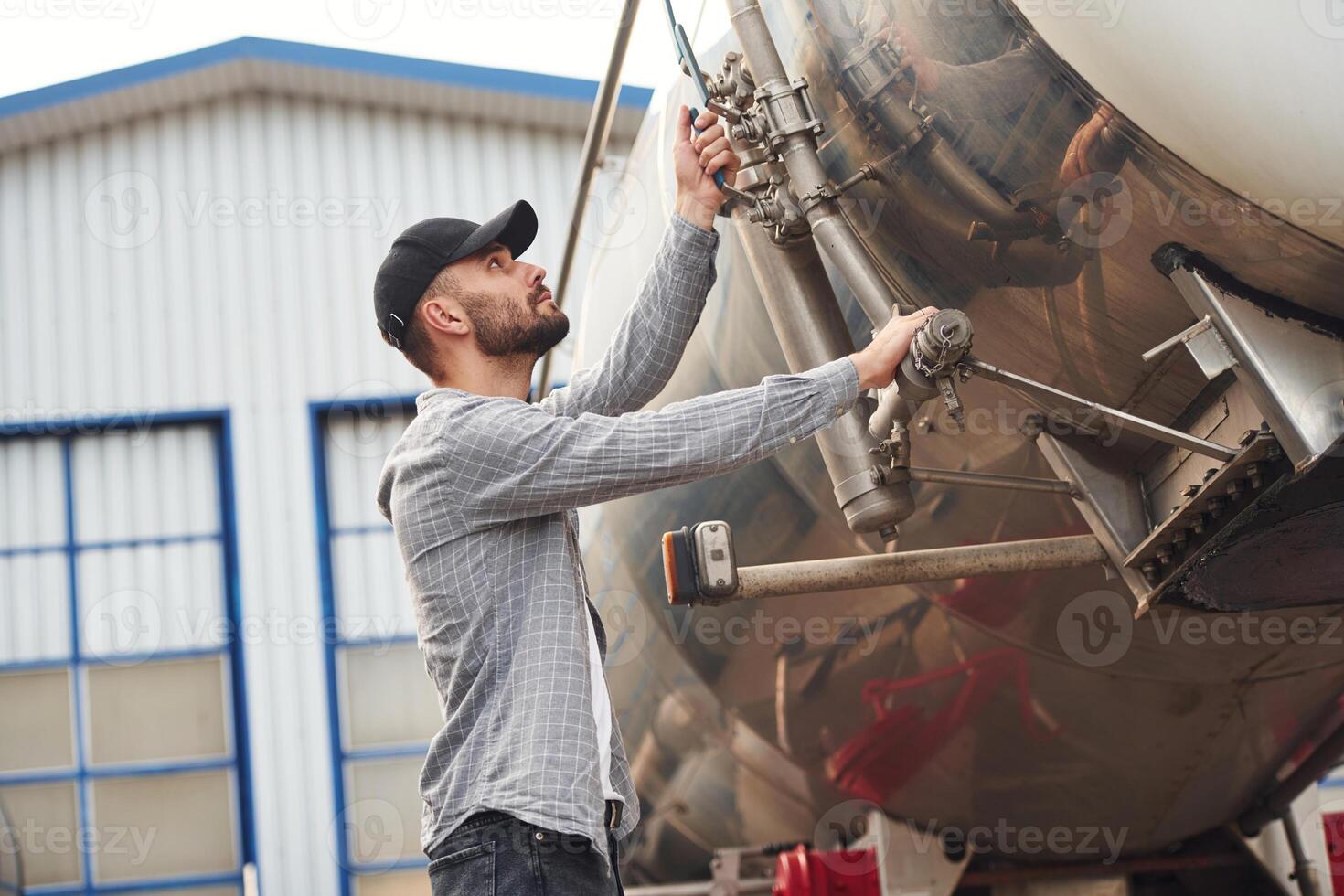 Quality control. Young truck driver ,in casual clothes photo