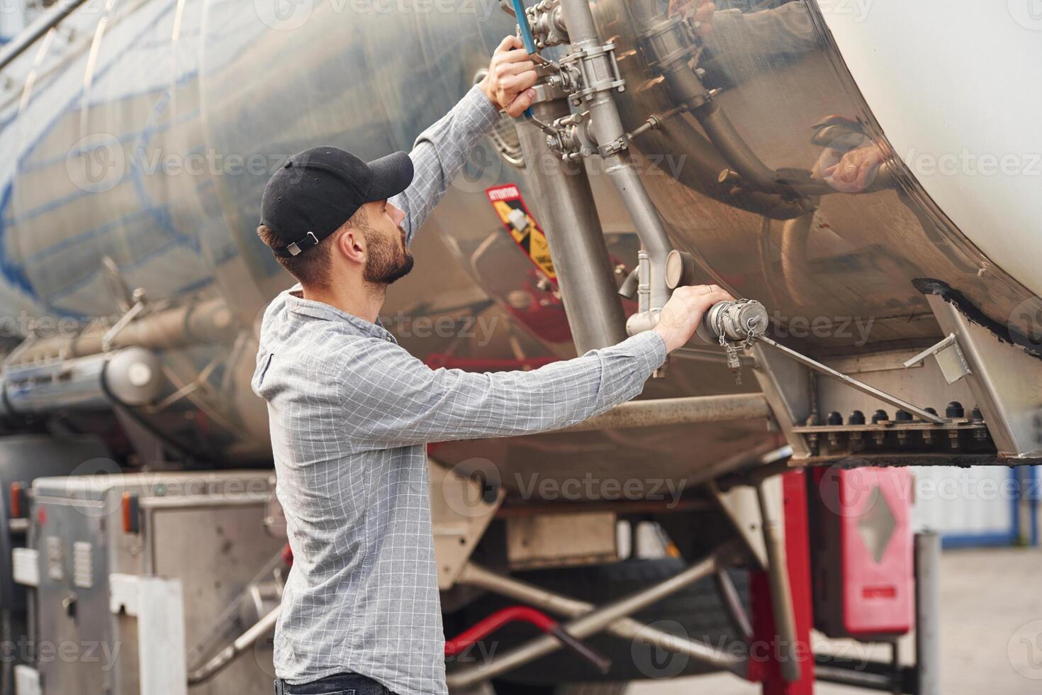 Quality, control. Young ,truck driver in casual clothes photo