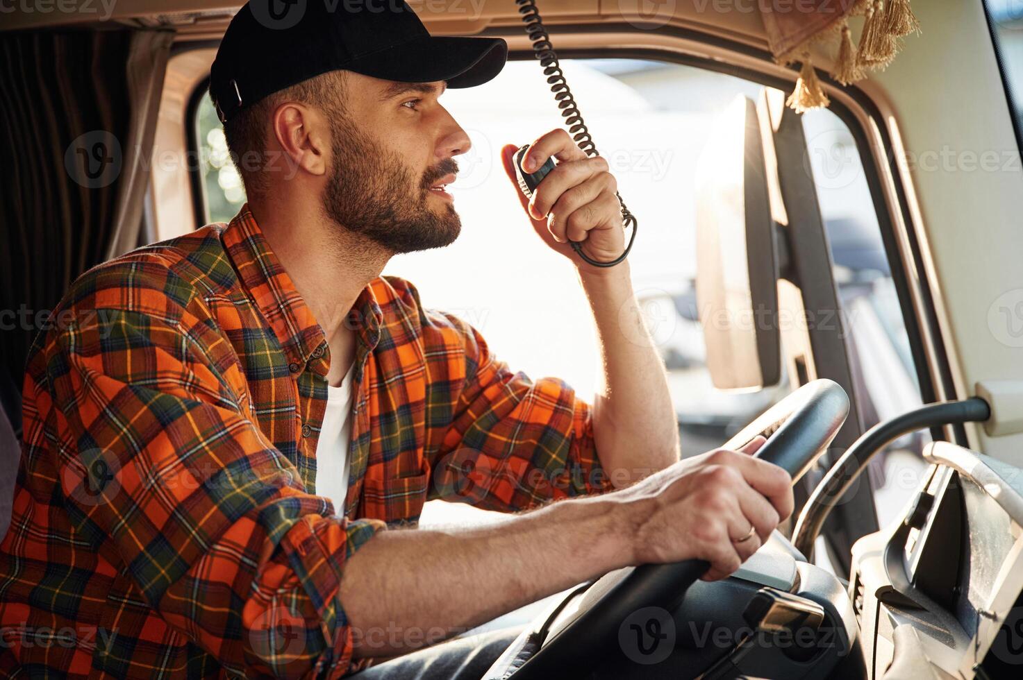 Talking by using radio., Young, truck driver in casual clothes photo