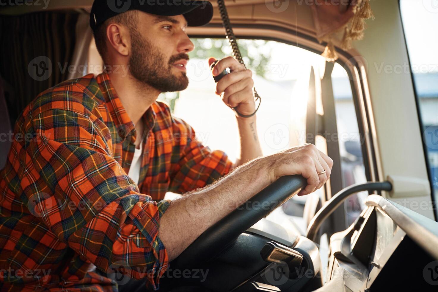 Radio ,communication. Young truck driver in casual clothes photo