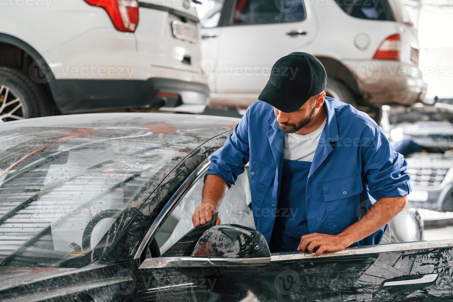 Dirty car is moved by auto mechanic that is in garage. Repair service photo