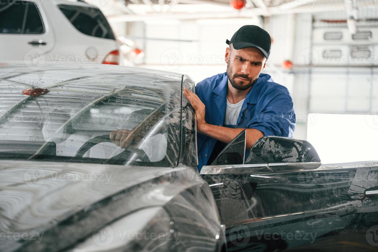 Moving ,the dirty, car that need washing. Auto mechanic working in garage. Repair service photo